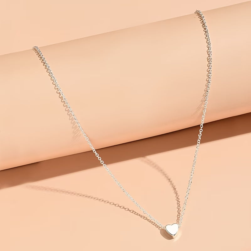 Collier petit cœur argenté fond neutre — bijou minimaliste femme Maison du Collier
